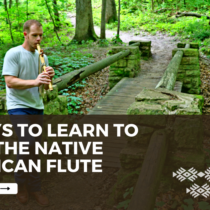 Jonny Lipford playing his native american flute in the woods for the blog post of 4 ways to learn to play the native american flute