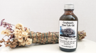 Bottle of Antiseptic Oil for Native Flutes shown beside sage wand