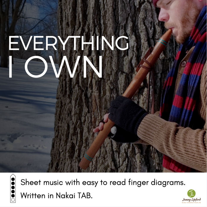 Jonny Lipford standing in front of a tree playing a Native American flute. This is the cover image for the Native American Flute Sheet Music to Everything I Own 