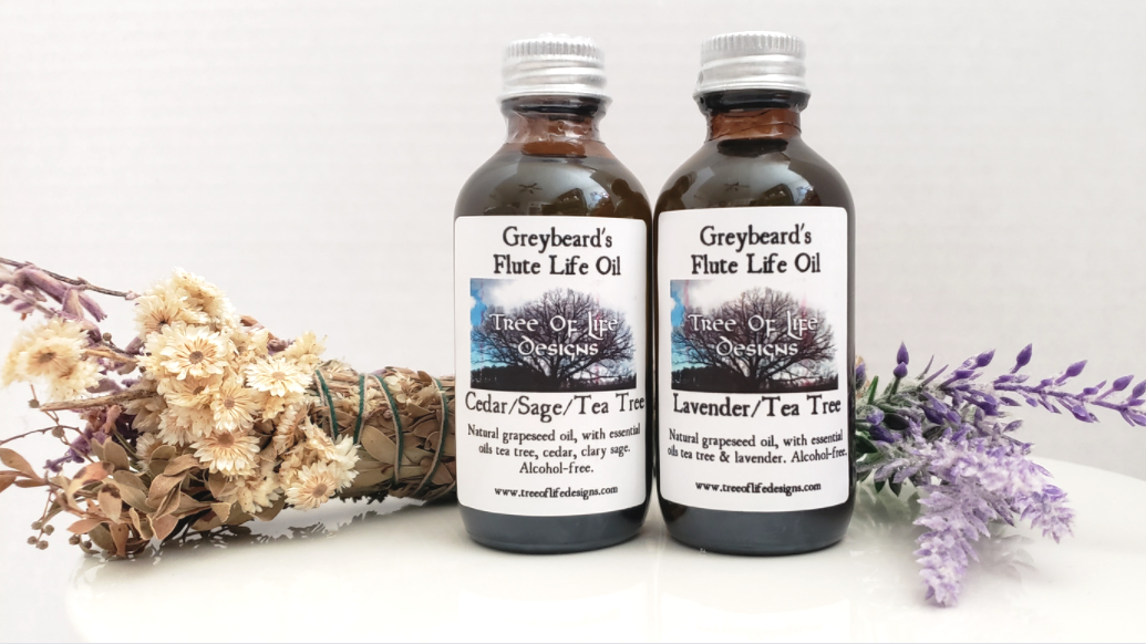 2 Bottles of Antiseptic Oil for Native Flutes shown with sage wand and lavender sprigs
